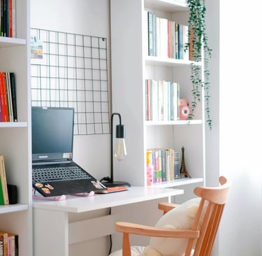 Small reading nook with desk, accent chair, lamp, and warm minimalist décor