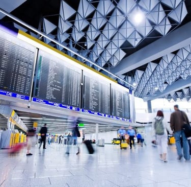 a group of people walking through a large airport