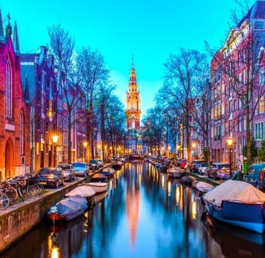 Amsterdam - a canal with boats and buildings in the background