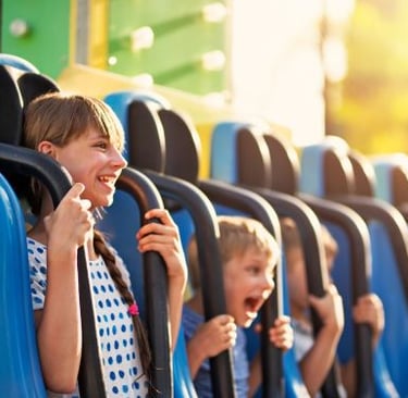 a group of children's riding on a roller coaster