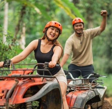 a man and woman riding on atvs in the woods