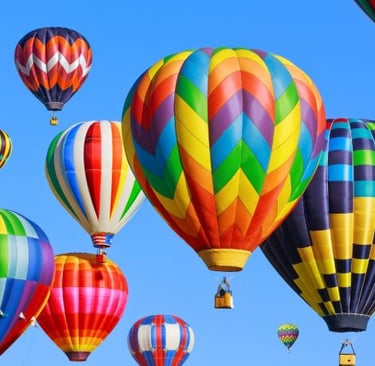 a bunch of colorful balloons in the sky