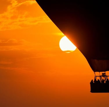 a hot air balloon in the sky with people in a hot air balloon