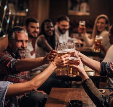 a group of people holding hands up in a toast