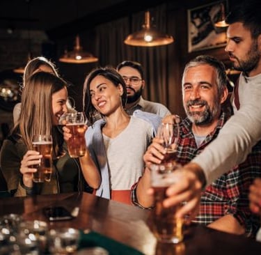 a group of friends having fun time together at a bar