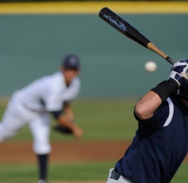 a baseball player is swinging a bat at a baseball game