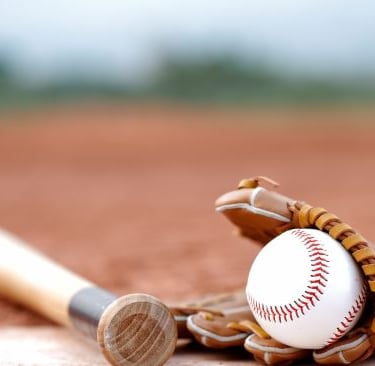 a baseball bat and a baseball glove on a baseball field