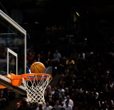 a basketball player is about to dunk the ball