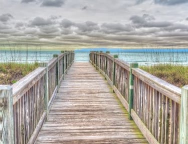 Beaufort - a wooden boardwalk with a wooden boardwalk leading to the beach