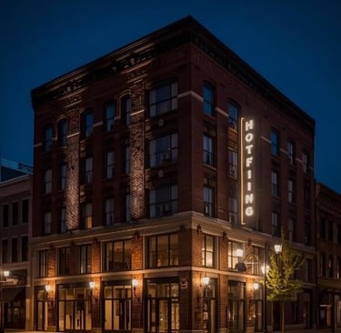 a hotel with a hotel sign on the side of the street