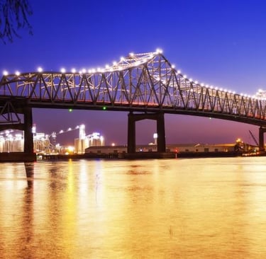 a bridge spanning a river with a bridge in the background