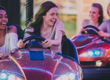 a group of friends enjoying a ride on a bumper car