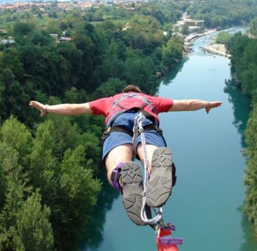 a man is hanging upside down on a rope