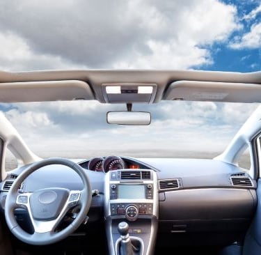 a car dashboard with a steering wheel and dashboard