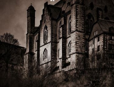 a creepy looking building with a clock tower in the background