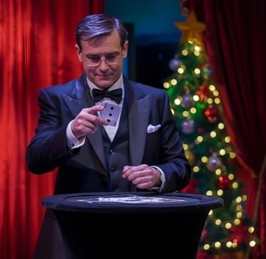 a magician doing a cart tric with a christmas tree in the background