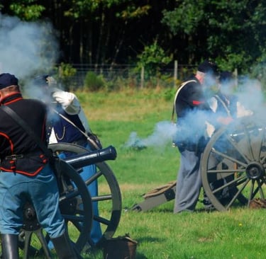 a group of men in uniform uniforms standing around a cannon