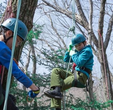 a boy and girl on a zip line