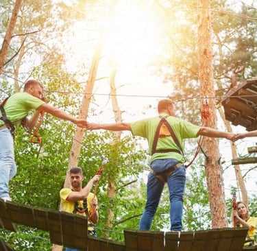 a group of people on a rope - tied rope course