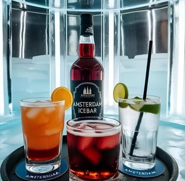 Colorful cocktails and a liquor bottle on a tray inside the frozen Amsterdam Icebar.
