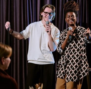 Two comedians performing in a theater