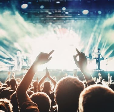 a crowd of people standing in front of a stage with a stage and a stage