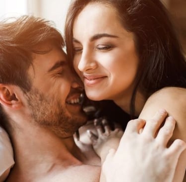 a man and woman are smiling and hugging