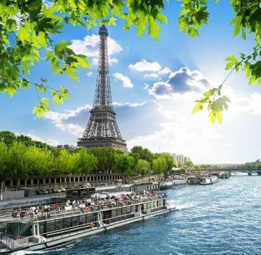 a boat on the river with a view of the eiffel tower