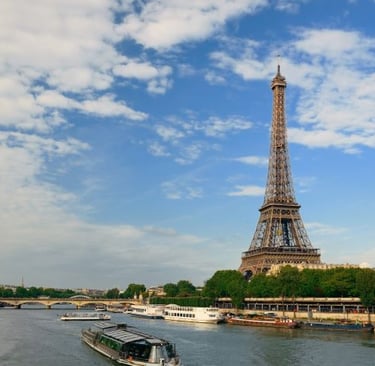 a boat on the river with a view of the eiffel tower