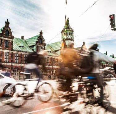 a group of people riding bikes down a street