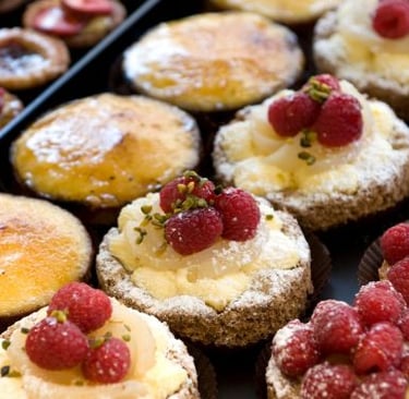 a tray of pastries with raspberry pies
