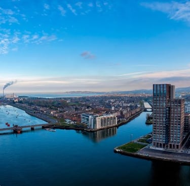 a river with a bridge and a city in the background