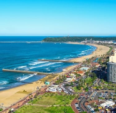 a beach with a view of the ocean and durban city