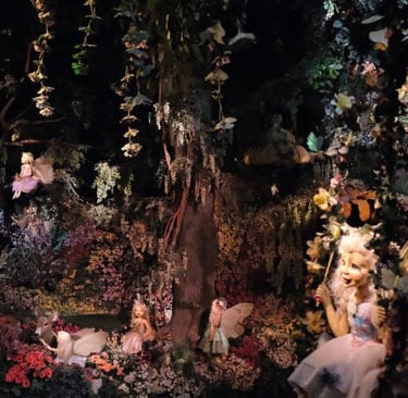 a display of fairy - themed items in a display case