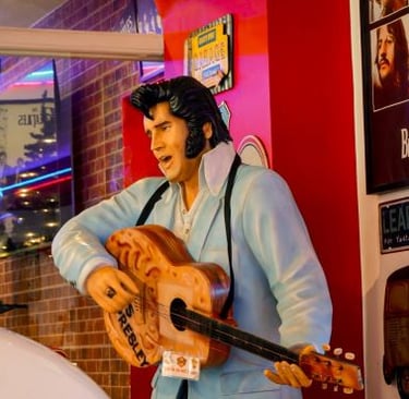 a statue of elvis presley playing guitar in a restaurant