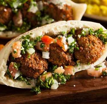 a meatball pita filled with vegetables and meatballs