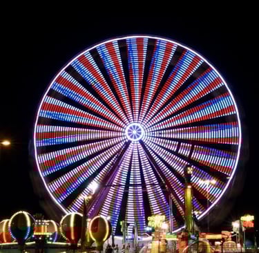 a ferris wheel with a ferris wheel in the middle of a night