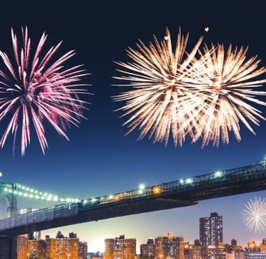 nyc - fireworks in the sky over a bridge and a city