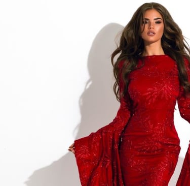 a woman in a red dress with a long sleeved dress