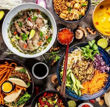 a variety of asian food dishes on a table
