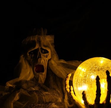 a scary looking ghost with a glowing ball in the dark