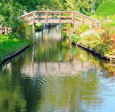 Giethoorn - a bridge over a river with a bridge over it