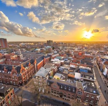 groningen -a cityscape of a city with a sunset