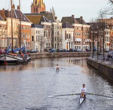 Groningen - a man rowing a boat on a river