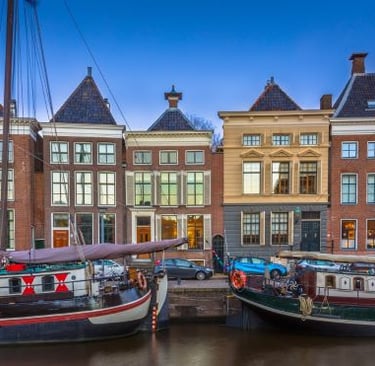 groningen - a boat is docked in a harbor with a boat in the water
