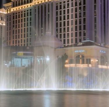 a fountain of water in front of a luxury hotel in Las Vegas