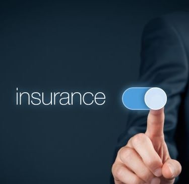 a man in a suit pointing at a button with the word insurance