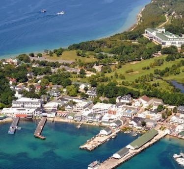 a large body of water with a boat in the background