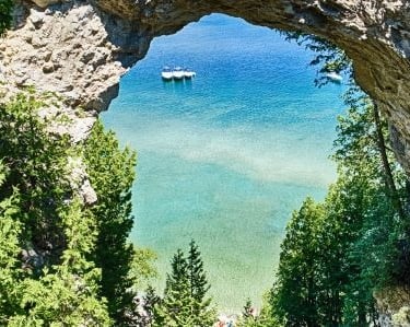 a boat is seen through a window of a cave