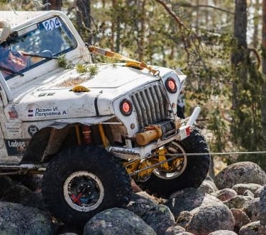 a jeep wrangling a jeep with a man in the background